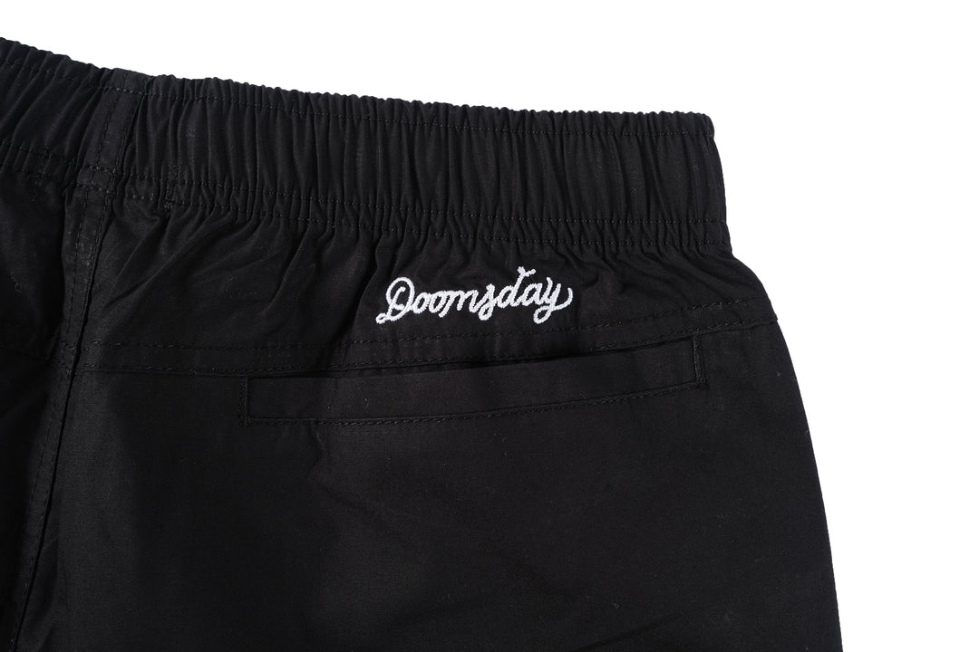 Baldo bonsai design embroidered onto the thigh of black beach shorts - doomsdayco Bonsai Black Beach Shorts back close up