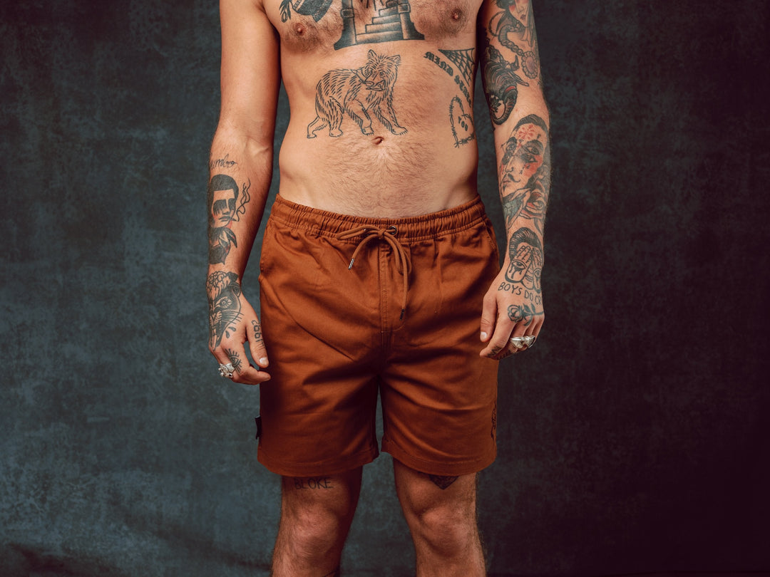 Model wearing Snake Brown Walk Shorts with pull string waist - doomsdayco Snake Brown Walk Shorts front