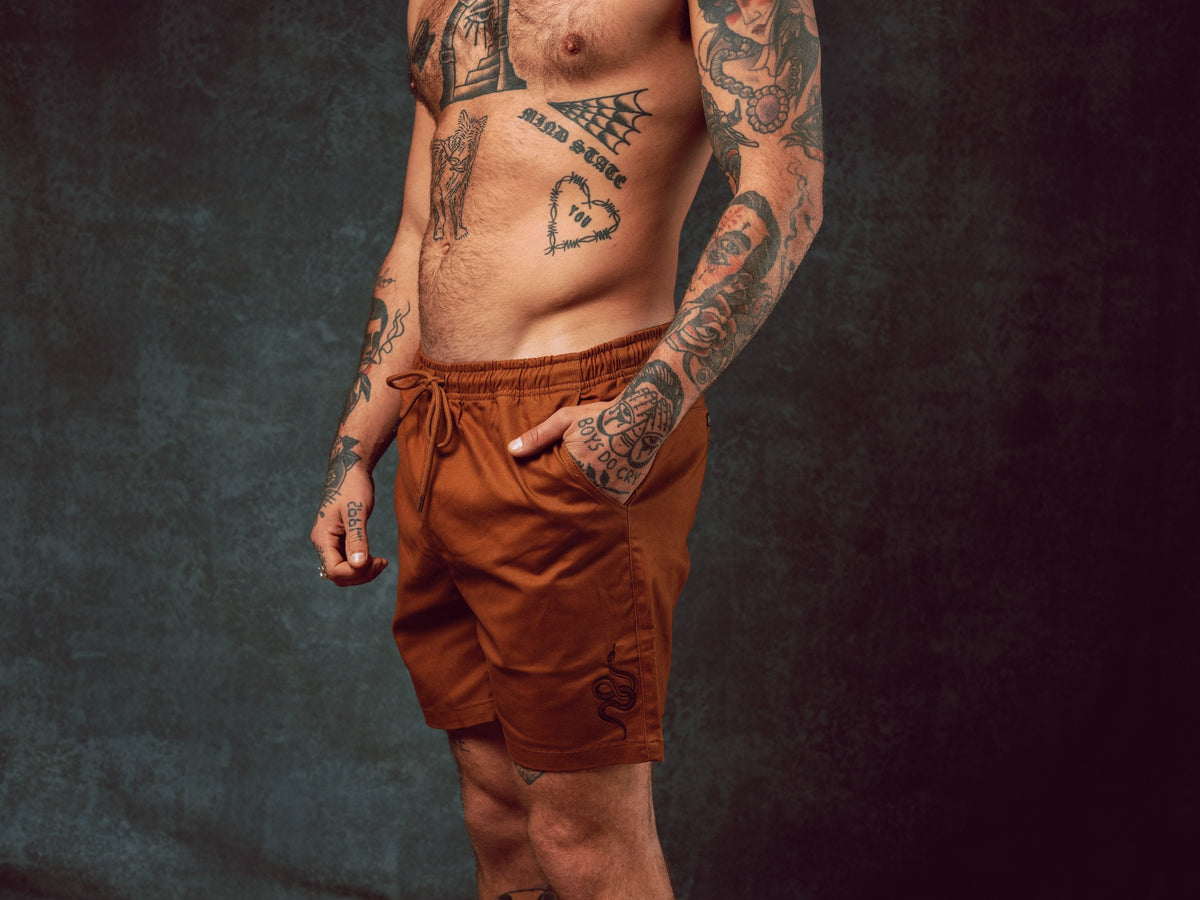 Model wearing Snake Brown Walk Shorts with pull string waist - doomsdayco Snake Brown Walk Shorts side