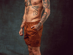 Model wearing Snake Brown Walk Shorts with pull string waist - doomsdayco Snake Brown Walk Shorts side